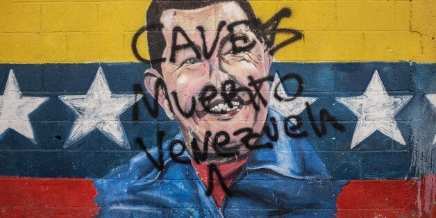 Picture of a graffiti depicting late Venezuelan President (1999-2013) Hugo Chavez, taken in Caracas on November 2, 2015. AFP PHOTO / FEDERICO PARRA / AFP / FEDERICO PARRA (Photo credit should read FEDERICO PARRA/AFP/Getty Images)