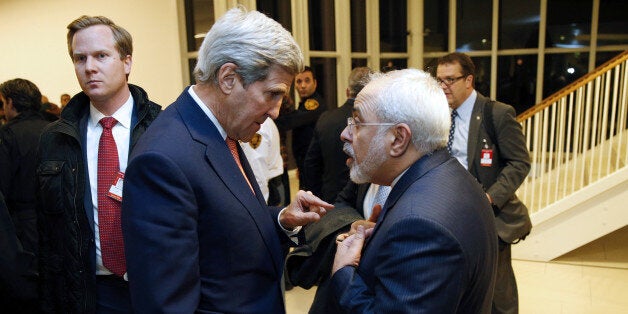 US Secretary of State John Kerry (L) speaks with Iranian Foreign Minister Mohammad Javad Zarif after the International Atomic Energy Agency (IAEA) verified that Iran has met all conditions under the nuclear deal during the E3/EU+3 and Iran talks in Vienna on January 16, 2016.The historic nuclear accord between Iran and major powers entered into force as the UN confirmed that Tehran has shrunk its atomic programme and as painful sanctions were lifted on the Islamic republic. / AFP / POOL / KEVIN LAMARQUE (Photo credit should read KEVIN LAMARQUE/AFP/Getty Images)