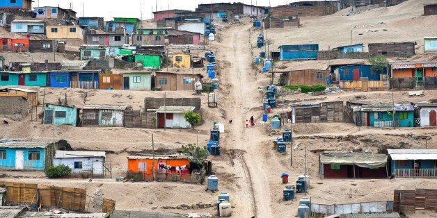LIMA, PERU - JANUARY 22: A Peruvian woman with her child climb up a steep path along the plastic water containers and tanks on the dusty hillside of Pachacútec, a desert suburb, on January 22, 2015 in Lima, Peru. Although Latin America is blessed with an abundance of fresh water, having 20% of global water resources in the the Amazon Basin and the highest annual rainfall of any region in the world, an estimated 50-70 million Latin Americans (one-tenth of the continent's population) lack access to safe water and 100 million people have no access to any safe sanitation. Complicated geographical conditions, unregulated industrialization and massive urban poverty, combined with deep social inequality, have caused a severe water supply shortage in many Latin American regions. (Photo by Jan Sochor/LatinContent/Getty Images)