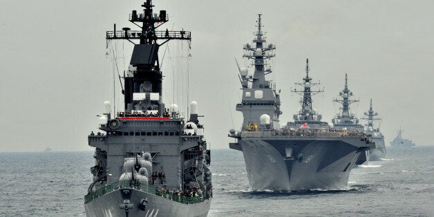 Japan Maritime Self-Defence Force escort ship Kurama (L) sails during their 2012 navy fleet review off Sagami Bay, Japan's Kanagawa prefecture on October 14, 2012. AFP PHOTO / KAZUHIRO NOGI (Photo credit should read KAZUHIRO NOGI/AFP/GettyImages)