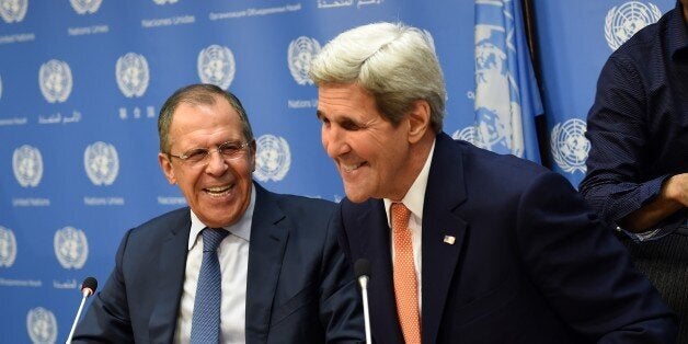 Foreign Minister of Russia Sergey Lavrov (L) and US Secretary of State John Kerry hold a news conference after a UN Security Council meeting on Syria at the United Nations in New York on December 18, 2015. The UN Security Council on Friday unanimously adopted a resolution endorsing a peace process to end the nearly five-year war in Syria. AFP PHOTO/ TIMOTHY A. CLARY / AFP / TIMOTHY A. CLARY (Photo credit should read TIMOTHY A. CLARY/AFP/Getty Images)