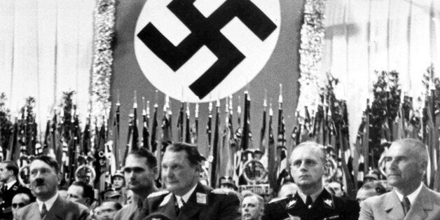 German Minister of Propoganda Dr. Joseph Goebbels, unseen, intoduces German Chancellor Adolf Hitler, left, to the large audience at the Sports Palace, in Berlin, on Sept. 26, 1938. Seated from left to right; Hitler; Rudolf Hess, Deputy Leader of the Nazi Party; Hermann Goering, President of the Reichstag; Joachim Von Ribbentrop, German Foreign Minister; Wilhelm Frick, German Minister of the Interior. (AP Photo)