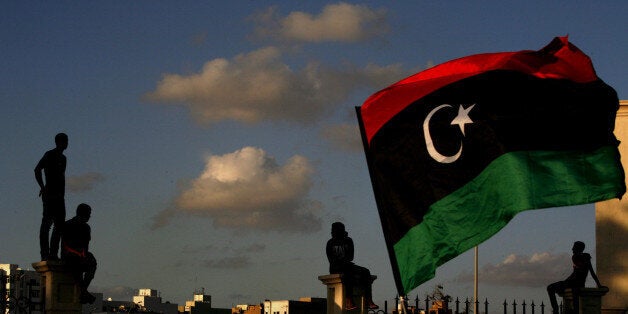 Libyans watch the protest against Ansar al-Shariah Brigades and other Islamic militias, in Benghazi, Libya, Friday, Sept. 21, 2012. The recent attack that killed the U.S. ambassador and three other Americans has sparked a backlash among frustrated Libyans against the heavily armed gunmen, including Islamic extremists, who run rampant in their cities. More than 10,000 people poured into a main boulevard of Benghazi, demanding that militias disband as the public tries to do what Libya's weak central government has been unable to.(AP Photo/Mohammad Hannon)