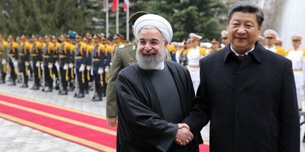 TEHRAN, IRAN - JANUARY 23 : Chinese President Xi Jinping (R) and Iranian President Hassan Rouhani (L) shake hands during an o