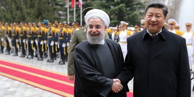 TEHRAN, IRAN - JANUARY 23 : Chinese President Xi Jinping (R) and Iranian President Hassan Rouhani (L) shake hands during an official welcoming ceremony prior to their meeting at Saadabad Palace in Tehran, Iran on January 23, 2016. (Photo by Pool / Iranian Presidency/Anadolu Agency/Getty Images)