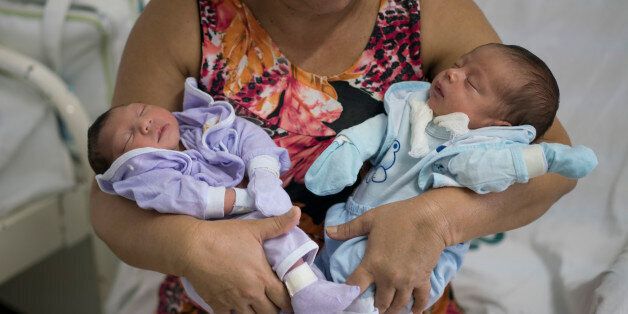 Severina Raimunda holds her granddaughter Melisa Vitoria, left, who was born with microcephaly and her twin brother Edison Junior at the IMIP hospital in Recife, Pernambuco state, Brazil, Wednesday, Feb. 3, 2016. The zika virus is spread by the Aedes aegypti mosquito, which is well-adapted to humans, thrives in people's homes and can breed in even a bottle cap's-worth of stagnant water. The Zika virus is suspected to cause microcephaly in newborn children. (AP Photo/Felipe Dana)