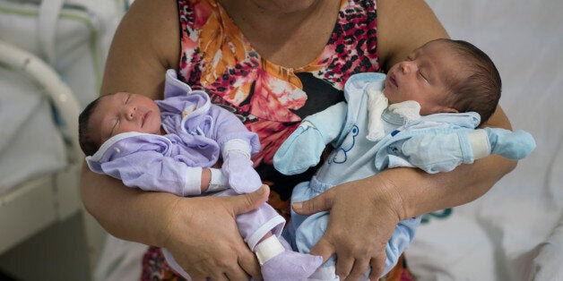 Severina Raimunda holds her granddaughter Melisa Vitoria, left, who was born with microcephaly and her twin brother Edison Ju