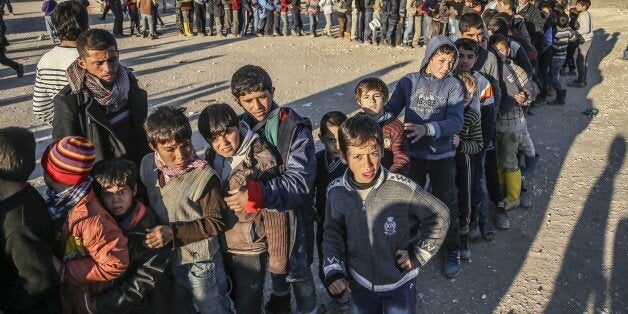 ALEPPO, SYRIA - FEBRUARY 10: Syrians, who fled bombing in Aleppo, are seen at a tent city and close to the Bab al-Salam border crossing on Turkish-Syrian border near Azaz town of Aleppo, Syria on February 10, 2016. Russian airstrikes have recently forced some 40,000 people to flee their homes in Syrias northern city of Aleppo. (Photo by Fatih Aktas/Anadolu Agency/Getty Images)