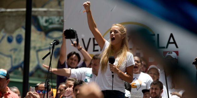 Lilian Tintori, wife of jailed opposition leader Leopoldo Lopez, cheers to supporters during a rally in Caracas, Venezuela, Saturday, Sept. 19, 2015. The opposition is starting their campaign for parliamentary elections, set for December, with demonstrations in Caracas and other cities, in an effort to animate an electorate amid an economic crisis and a growing crime. (AP Photo/Fernando Llano)