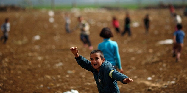 A Syrian refugee boys play at a refugee camp in the town of Hosh Hareem, in the Bekaa valley, east Lebanon, Wednesday, Oct. 28, 2015. The United Nations said Tuesday the worsening conflict in Syria has left 13.5 million people in need of aid and some form of protection, including more than six million children. (AP Photo/Hassan Ammar)