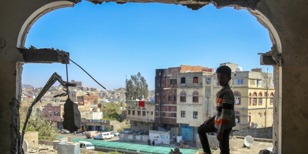 TOPSHOT - A Yemeni boy checks the damage following a mortar shell attack on the country's flashpoint southern city of Taez on February 3, 2016, as clashes between fighters from the Popular Resistance Committees, loyal to Yemen's fugitive President and Shiite Huthi rebels continue.The city of Taez is held by loyalists of Yemen's internationally recognised government, but it has been besieged by the Iran-backed rebels for months. Abedrabbo Mansour Hadi loyalists backed by a Saudi-led coalition have fought back and have been trying to retake Taez province and pave the way towards the rebel-held capital. / AFP / AHMAD AL-BASHA (Photo credit should read AHMAD AL-BASHA/AFP/Getty Images)