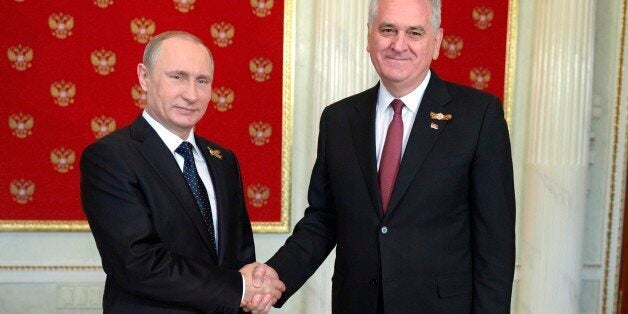 Russian President Vladimir Putin, left, and Serbian President Tomislav Nikolic shake hands at their meeting in the Kremlin in Moscow, Russia, Saturday, May 9, 2015. Tomislav Nikolic is attending the celebrations marking the 70th anniversary of victory over Nazi Germany. (Alexei Nikolsky/RIA-Novosti, Kremlin Pool Photo via AP)