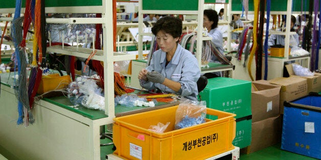 In this Sept. 21, 2012 photo, a North Korean worker handles wires at a South Korean-run factory inside the Kaesong industrial