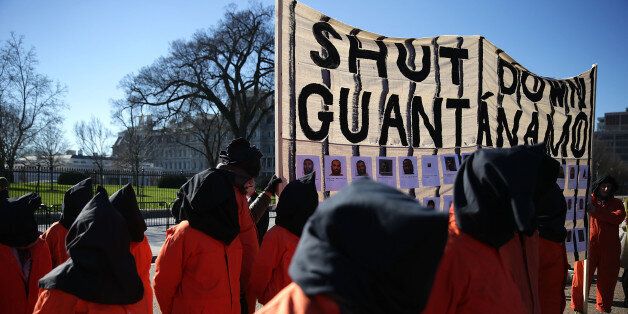 WASHINGTON, DC - JANUARY 11: Activists in orange jump suit participate in a rally in front of the White House to demand the closure of Guantanamo Bay detention camp January 11, 2016 in Washington, DC. Activists staged the rally to call on President Barack Obama to keep his promise to shut down the detention site in Cuba. (Photo by Alex Wong/Getty Images)