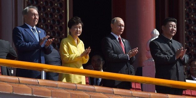 Kazakhstan President Nursultan Nazarbayev (L), South Korea's President Park Geun-hye (2nd L), Russia's President Vladimir Putin (2nd R) and Chinese President Xi Jinping (R) applaud during a military parade in Tiananmen Square in Beijing on September 3, 2015, to mark the 70th anniversary of victory over Japan and the end of World War II. China kicked off a huge military ceremony marking the 70th anniversary of Japan's defeat in World War II on September 3, as major Western leaders stayed away. AFP PHOTO / POOL / WANG ZHAO (Photo credit should read WANG ZHAO/AFP/Getty Images)