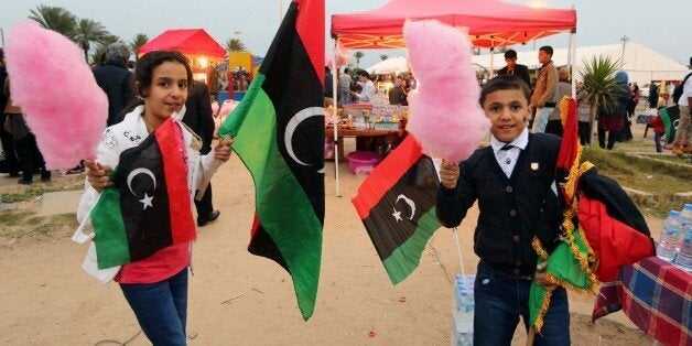 Libyans wave national flags as they gather at Martyrs' Square in the capital Tripoli on February 16, 2016 to attend the celebrations marking the fifth anniversary of the Libyan revolution which toppled strongman Moamer Kadhafi.Five years after the death of dictator Moamer Kadhafi, many Libyans have lost hope of seeing the rule of law return to a divided country threatened by jihadist expansion. / AFP / MAHMUD TURKIA (Photo credit should read MAHMUD TURKIA/AFP/Getty Images)