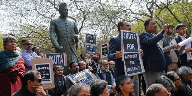 Teachers gather near a statue of Jawaharlal Nehru during a protest at the Jawaharlal Nehru University against the arrest of a student union leader in New Delhi, India, Tuesday, Feb. 16, 2016. Students, journalists and teachers protested in the Indian capital Tuesday after a student union leader's arrest and subsequent violence by Hindu nationalists.The uproar has once again sparked allegations that Prime Minister Narendra Modi's government and his Hindu nationalist Bharatiya Janata Party are displaying intolerance and cracking down on political dissent in the name of patriotism. (AP Photo /Tsering Topgyal)