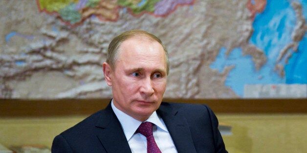 Russian President Vladimir Putin listens to President of Russia's Union of Industrialists and Entrepreneurs (RSPP) Alexander