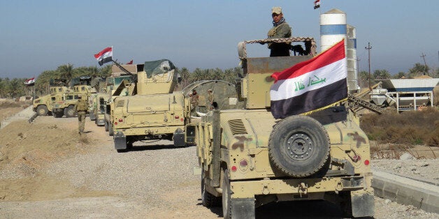 Iraqi government forces patrol the al-Hamidiyah area, north of Ramadi, on February 17, 2016 after security forces retook the