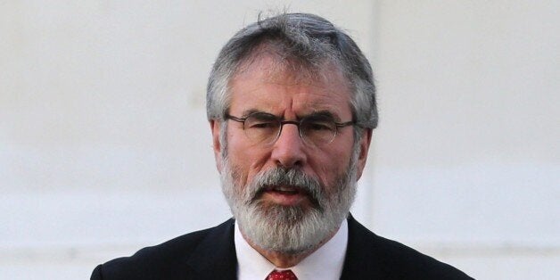 Irish republican politician and president of the Sinn Féin political party Gerry Adams talks to the press on December 4, 201