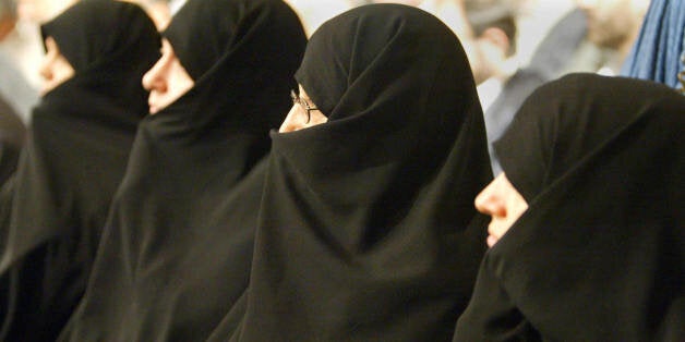 TEHRAN, IRAN: Iranian women MPs partricipate in the joint session of the cabinet and parliament in Tehran, 18 August 2004. Twelve MPs from 12 Majlis commissions are to air their views on various issues tabled for discussion during the session. Majlis (Parliament) Speaker Gholam-Ali Haddad Adel stressed on the sidelines of the open session that while the government and parliament may have different views, they both have common legal commitments. Iran's conservative-dominated parliament voted down a bid by its reformist predecessor to support women's rights and enforce gender equality.AFP PHOTO/Henghameh FAHIMI (Photo credit should read HENGHAMEH FAHIMI/AFP/Getty Images)