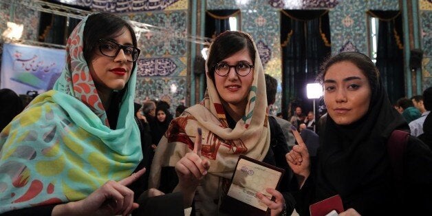 TEHRAN, IRAN - FEBRUARY 26: Iranians display their ink-stained fingers after casting their ballots for both parliamentary elections and the Assembly of Experts at a polling station in Tehran on February 26, 2016. (Photo by Fatemeh Bahrami/Anadolu Agency/Getty Images)