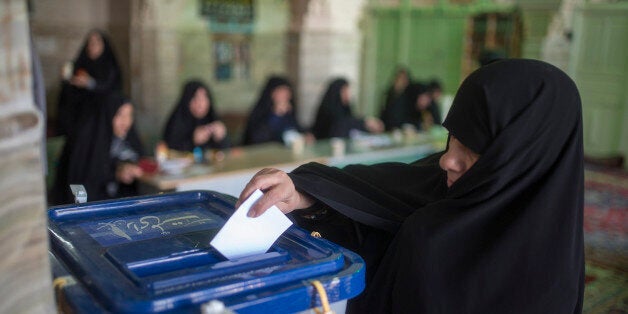 TEHRAN, IRAN - FEBRUARY 26: An Iranian woman votes in the parliamentary and Experts Assembly elections at a polling station in Qom, 125 kilometers (78 miles) south of the capital on February 26, 2016 in Tehran, Iran. Iranians voted on Friday in parliamentary elections, the country's first since its landmark nuclear deal with world powers last summer. (Photo by Majid Saeedi/Getty Images)