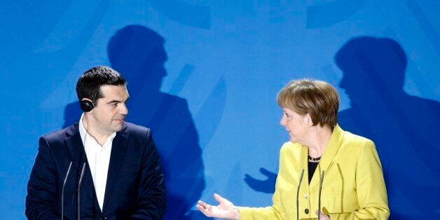 FILE - In this March 23, 2015 file photo German Chancellor Angela Merkel, right, and the Prime Minister of Greece Alexis Tsipras brief the media during a bilateral meeting at the chancellery in Berlin. Merkel has been named Times' Person of the Year, praised by the magazine for her leadership on everything from Syrian refugees to the Greek debt crisis. (AP Photo/Markus Schreiber, file)