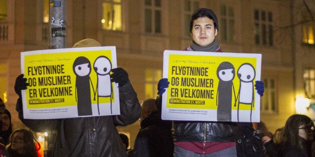 COPENHAGEN, DENMARK - JANUARY 19: The counter-demonstrators hold placards reading in 'Refugees and Muslims are welcome' during a protest against Pediga.dk movement in Copenhagen, Denmark on January 19, 2015. The Danish version of German Pediga movement Pediga.dk has held it's first demonstration ever in Denmark to protest against 'Fundamentalist Islam' at 18.00 o'clock. To protest against this demonstration, a counter-demonstration by the Anti-Fascist movement in the Danish capital, Copenhagen, that call themselves: 'Revolutionary Antifascists', was organized on the same day, started at 17.00 o'clock. (Photo by Freya Ingrid Morales/Anadolu Agency/Getty Images)