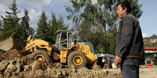 A Chinese construction worker supervise the building of a road, Thursday, April 26, 2007 in the Ethiopian capital, Addis Ababa. China said Thursday that a deadly attack in Ethiopia that killed 74 people, including nine Chinese, will not stop it from investing in Africa, but added it planned to boost security measures. (AP Photo/Karel Prinsloo)