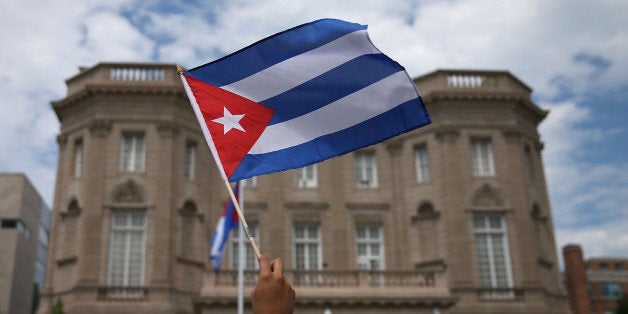 WASHINGTON, DC - JULY 20: A supporter waves a Cuban flag in front of the country's embassy after it re-opened for the first time in 54 years July 20, 2015 in Washington, DC. The embassy was closed in 1961 when U.S. President Dwight Eisenhower severed diplomatic ties with the island nation after Fidel Castro took power in a Communist revolution. (Photo by Mark Wilson/Getty Images)