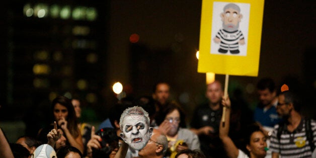 People demonstrate against former Brazilian president Luiz Inacio Lula da Silva at Paulista Avenue in dowtown Sao Paulo on March 4, 2016. Brazil's powerful Lula da Silva lashed out at prosecutors Friday after he was briefly detained by police as part of a probe into a massive corruption scheme. During a defiant press conference shortly after being freed, Lula, 70, said the decision to take him forcibly into custody for questioning about links to a corruption network at state oil company Petrobras amounted to 'judicial authoritarianism.' AFP PHOTO / Miguel SCHINCARIOL / AFP / Miguel Schincariol (Photo credit should read MIGUEL SCHINCARIOL/AFP/Getty Images)