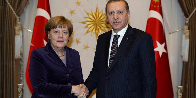 Turkish President Recep Tayyip Erdogan, right, and German Chancellor Angela Merkel shake hands before a meeting in Ankara, Turkey, Monday, Feb. 8, 2016. Turkey and Germany agreed on Monday on a set of measures to deal with the Syrian refugee crisis, including a joint diplomatic initiative aiming to halt attacks against Syriaâs largest city. Merkel said after talks with Prime Minister Ahmet Davutoglu that she is ânot just appalled but horrifiedâ by the suffering caused by Russian bombing in Syria.( Yasmin Bulbul/Presidential Press Service, Pool via AP)