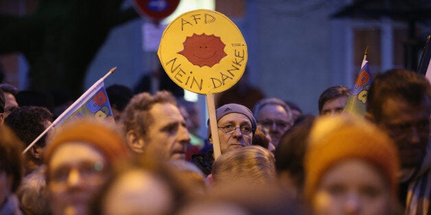 BADEN-BADEN, GERMANY - MARCH 07: Protesters, one of whom is holding a sign that reads: 'AfD, no thank you,' demonstrate outside the venue of an AfD (Alternative fuer Deutschland, or Alternative for Germany) political party, Baden-Wuerttemberg state election campaign gathering on March 7, 2016 in Baden-Baden, Germany. State elections scheduled for March 13 in three German states: Rhineland-Palatinate, Saxony-Anhalt and Baden-Wuerttemberg, will be a crucial test-case for German Chancellor and Chairwoman of the German Christian Democrats (CDU) Angela Merkel, who has come under increasing pressure over her liberal immigration policy towards migrants and refugees. The AfD, with campaign rhetoric aimed at Germans who are uneasy with so many newcomers, has solid polling numbers and will almost certainly win seats in all three state parliaments. (Photo by Sean Gallup/Getty Images)