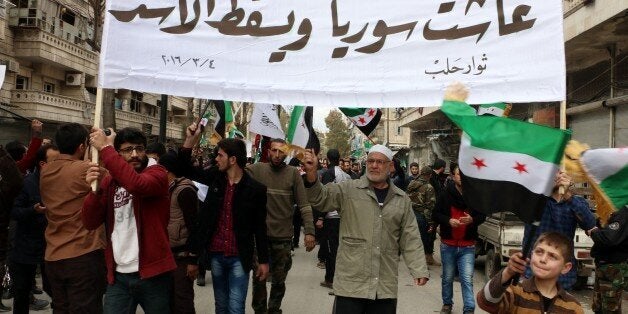 ALEPPO, SYRIA - MARCH 4: Syrian opponents gathered at the Tarik al-Bab neighborhood stage a protest against the Assad regime and Russia after the Friday prayers in Aleppo, Syria on March 4, 2016. (Photo by Beha el Halebi/Anadolu Agency/Getty Images)