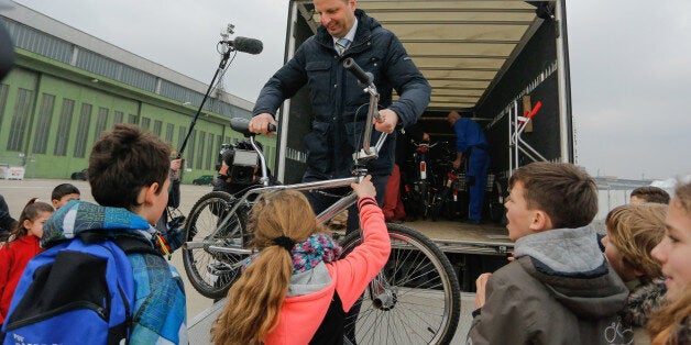 BERLIN, GERMANY - MARCH 10: Thomas Heilmann, Berlin Justice Senator (CDU) hands over repaired cycles to refugee children next