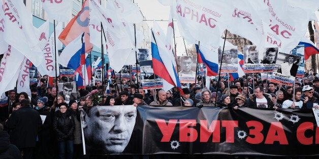 MOSCOW, RUSSIA - FEBRUARY 27: Supporters of slain Russian opposition leader Boris Nemtsov hold a banner reading 'Killed for freedom' during a memorial march marking the one-year anniversary of Nemtsovs assassination in central Moscow on February 27, 2016 in Moscow, Russia. The assassination of Boris Nemtsov, a Russian statesman and politician opposed to the government of Vladimir Putin, happened in central Moscow on 27 February 2015. (Photo by Oleg Nikishin/Epsilon/Getty Images)