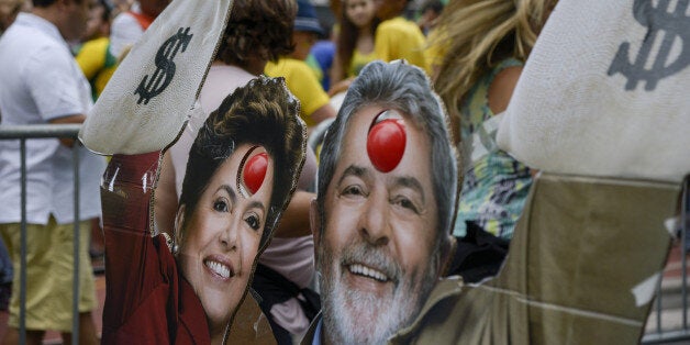 Cardboard cut out figures in the likenesses of Luiz Inacio Lula Da Silva, former president of Brazil, and Dilma Rousseff, Brazil's President, are seen during a protest against Rousseff and the ruling Workers Party (PT) in Sao Paulo, Brazil, on Sunday, March 13, 2016. Hundreds of thousands of Brazilians gathered across Brazil on Sunday to protest political corruption, a weak economy, and to call for the impeachment of Rousseff on a day that could build momentum for efforts to oust her. Photographer: Lula Marques/Bloomberg via Getty Images