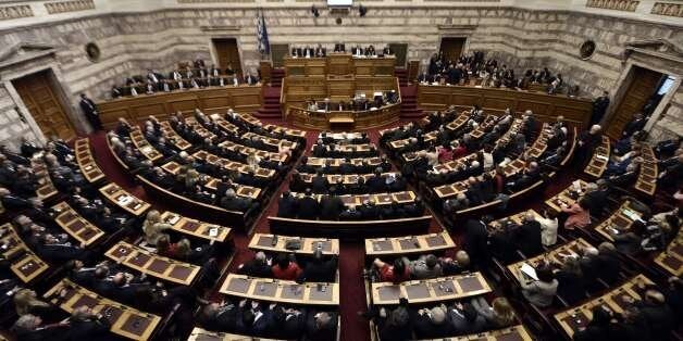 Greek lawmakers vote during the third round of a three-stage presidential election at the Greek parliament in Athens, on December 29, 2014. Greece's parliament on Monday failed for a third time to elect a president forcing early elections in the coming weeks that could see a radical left party win power. The government candidate fell short of securing the 180 votes required, and under the constitution parliament will have to be dissolved in the next 10 days. AFP PHOTO / ARIS MESSINIS (Photo credit should read ARIS MESSINIS/AFP/Getty Images)