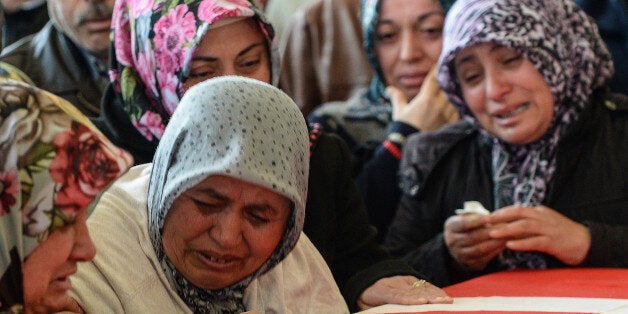 ANKARA, TURKEY - MARCH 14: Family members and relatives of car bombing victim Murat Gul mourn over a coffin during the funeral ceremony in a mosque on March 14, 2016 in Ankara, Turkey. Turkish President Recep Tayyip Erdogan vowed to defeat terrorism after 37 people were killed and 125 people injured when a car bomb exploded on March 13th in the busy square in Turkish capital of Ankara. Sources suggest the suspected bomber was a female member of the outlawed Kurdistan WorkersParty (PKK). (Photo by Gokhan Tan/Getty Images)