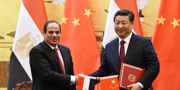 Egypt's President Abdel-Fattah el-Sissi, left, shakes hands with Chinese President Xi Jinping during a signing ceremony in Beijing's Great Hall of the People Tuesday, Dec. 23, 2014. (AP Photo/Greg Baker, Pool)