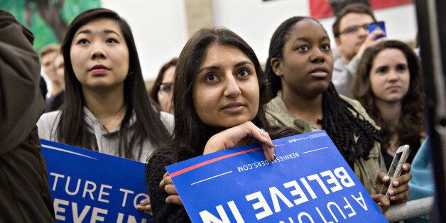 Attendees listen as Senator Bernie Sanders, an independent from Vermont and 2016 Democratic presidential candidate, not pictured, speaks during a campaign event at the University of Illinois in Champaign, Illinois, U.S., on Saturday, March 12, 2016. Ohio must let 17-year-olds vote in the states March 15 primary, if they turn 18 by Election Day, a judge ruled in a boost to Sanders. Photographer: Daniel Acker/Bloomberg via Getty Images