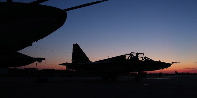 KRASNODAR TERRITORY, RUSSIA. MARCH 17, 2016. Russian Aerospace Force Sukhoi Su 25 fighter bombers, which have returned from Syria, pictured at a military installation in the Krasnodar Territory at dusk. The Russian president has announced the withdrawal of the main part of Russia's military contingent from Syria, starting on March 15, 2016. Vadim Grishankin/Russian Defence Ministry Press and Information Office/TASS (Photo by TASS\TASS via Getty Images)