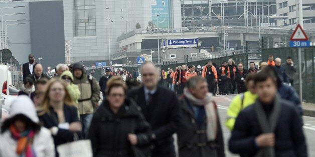 People are evacuated from Brussels Airport, in Zaventem, on March 22, 2016. after at least 13 people have been killed by two explosions in the departure hall of Brussels Airport. / AFP / Belga / LAURIE DIEFFEMBACQ / Belgium OUT (Photo credit should read LAURIE DIEFFEMBACQ/AFP/Getty Images)