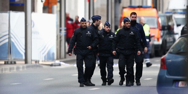 BRUSSELS, BELGIUM - MARCH 22: Police officers patrol outside Maelbeek metro station following todays attack on March 22, 201