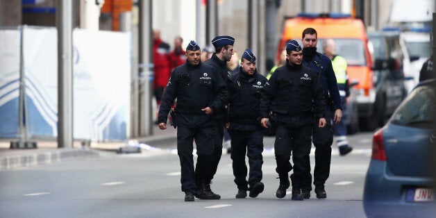 BRUSSELS, BELGIUM - MARCH 22: Police officers patrol outside Maelbeek metro station following todays attack on March 22, 2016 in Brussels, Belgium. At least 34 people are thought to have been killed after Brussels airport and a Metro station were targeted by explosions. The attacks come just days after a key suspect in the Paris attacks, Salah Abdeslam, was captured in Brussels. (Photo by Carl Court/Getty Images)