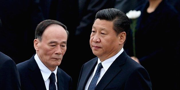 BEIJING, CHINA - SEPTEMBER 30: Chinese President Xi Jinping (R) and Secretary of the Central Commission for Discipline Inspection Wang Qishan (L) arrive the Monument to the People's Heroes during a ceremony marking Martyr(degrees)Â¯s Day at Tiananmen Square on September 30, 2014 in Beijing, China. China's top legislature approved September 30 as the Martyrs' Day last month. (Photo by Feng Li/Getty Images)