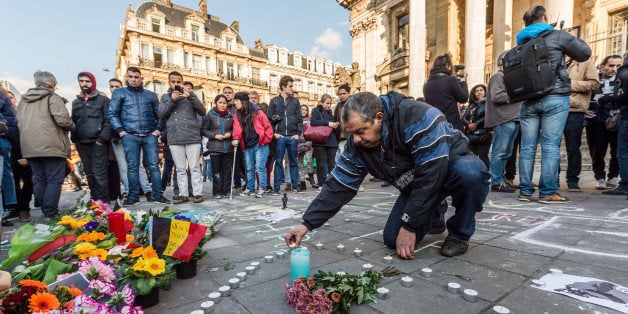 People light candles in the shape of a heart outside the stock exchange in Brussels on Tuesday, March 22, 2016. Explosions, at least one likely caused by a suicide bomber, rocked the Brussels airport and subway system Tuesday, prompting a lockdown of the Belgian capital and heightened security across Europe. (AP Photo/Geert Vanden Wijngaert)