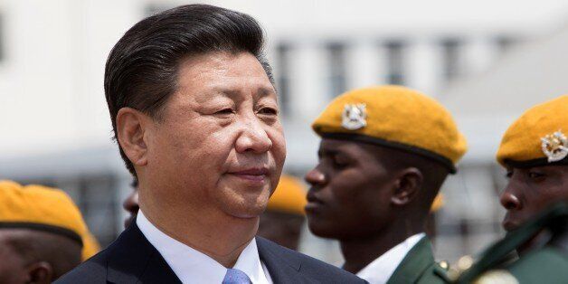 Chinese President Xi Jinping inspects the guard of honour following his arrival in Harare where China and Zimbabwe are scheduled to sign various economic deals in agriculture, energy and infrastructure development December 1 2015. China's President Xi Jinping started a five-day visit to Zimbabwe and South Africa, with African concern over the impact of the Chinese economic slowdown set to dominate the agenda. Xi will be the most prominent global leader to visit Zimbabwe for many years as veteran President Robert Mugabe, 91, is widely shunned by Western powers. / AFP / JEKESAI NJIKIZANA (Photo credit should read JEKESAI NJIKIZANA/AFP/Getty Images)