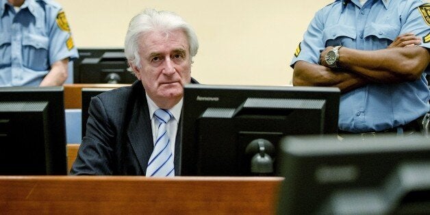 Bosnian Serb wartime leader Radovan Karadzic sits in the courtroom for the reading of his verdict at the International Criminal Tribunal for Former Yugoslavia (ICTY) in The Hague, on March 24, 2016.The former Bosnian-Serbs leader is indicted for genocide, crimes against humanity, and war crimes. / AFP / POOL / Robin van Lonkhuijsen / Netherlands OUT (Photo credit should read ROBIN VAN LONKHUIJSEN/AFP/Getty Images)